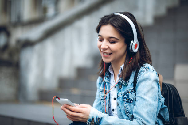 istock Using phone and listening to music 1202700748