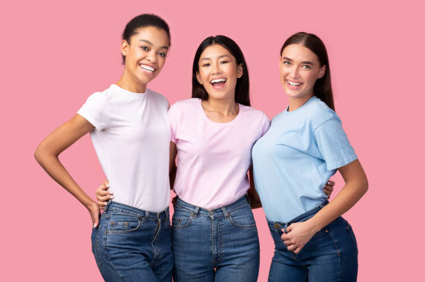 istock Three Joyful Women Hugging On Pink Background 1202700928