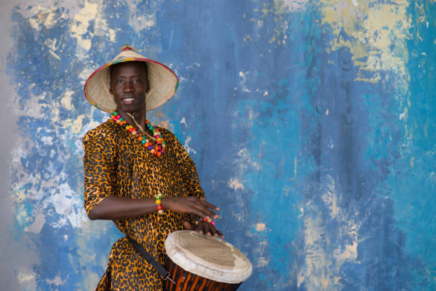 istock African man in traditional clothes playing djembe drum 1202700992