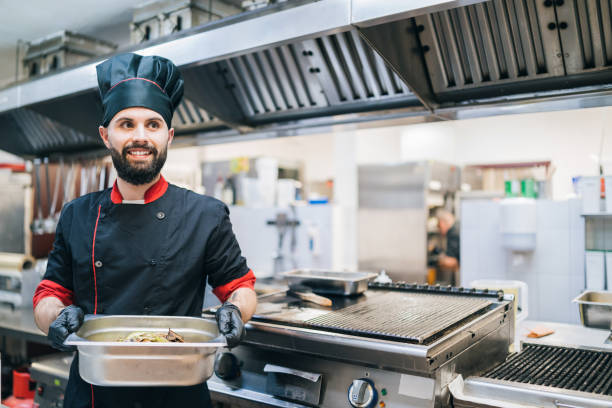 istock Chef preparing food commercial kitchen 1202702617