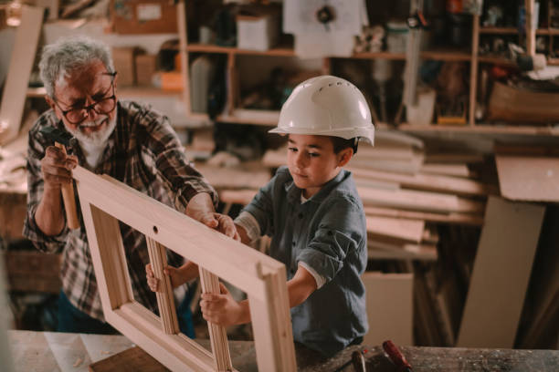 istock Senior carpenter and his grandson having fun in the workshop 1202704002