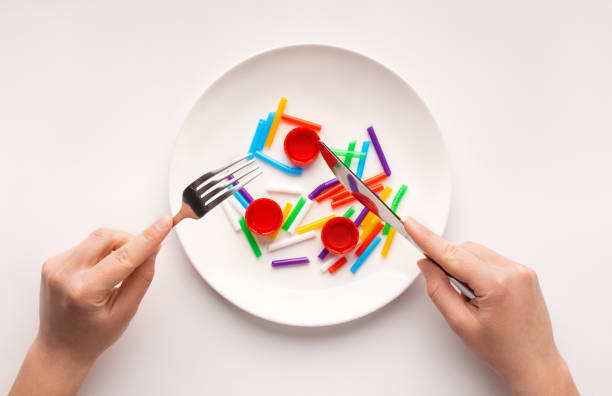 Plastic trash ready to eat in plate for lunch, white background Choose reusable. Plastic trash ready to eat in plate for lunch, white background microplastic stock pictures, royalty-free photos & images