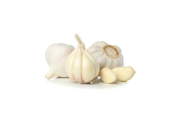 istock Fresh garlic bulbs and slices isolated on white background 1202704881
