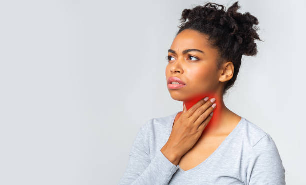 istock Black woman suffering from sore throat, touching her neck 1202704889