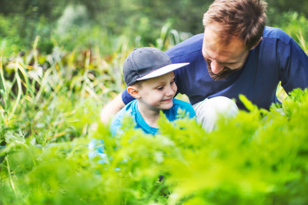 istock Father and son in a greenhouse 1202706009