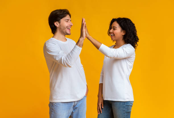 istock White Guy And Black Girl Giving High-Five To Each Other 1202706069