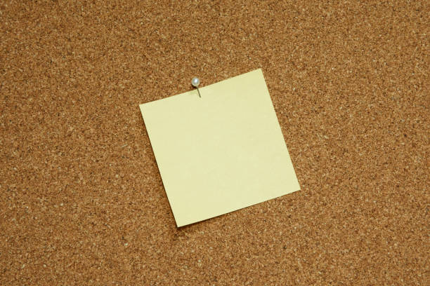 istock yellow blank note paper on bulletin board 1202707158