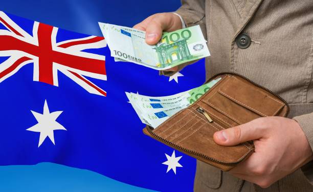 Investing money to Australia. Rich man with a lot of money. Investing money to Australia. Rich man with a lot of money in his hands and national flag on background. Highest Paying Jobs in Australia stock pictures, royalty-free photos & images