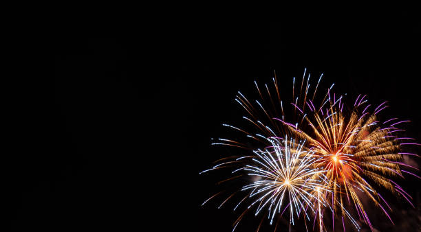 istock White and gold starburst fireworks with pink highlights with a black background 1202708577