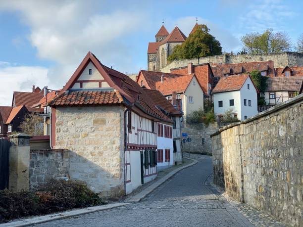 Quedlinburg, Germany - November, 7 - 2019:  View of the old town with cobblestone streets and typical houses. Church St. Servatius on top.