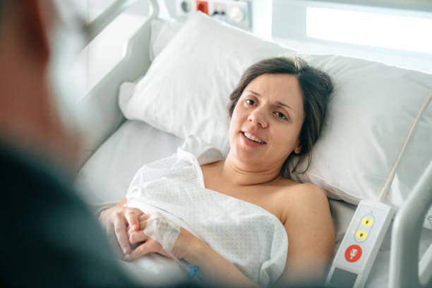istock Woman lying on bed at hospital 1202709265