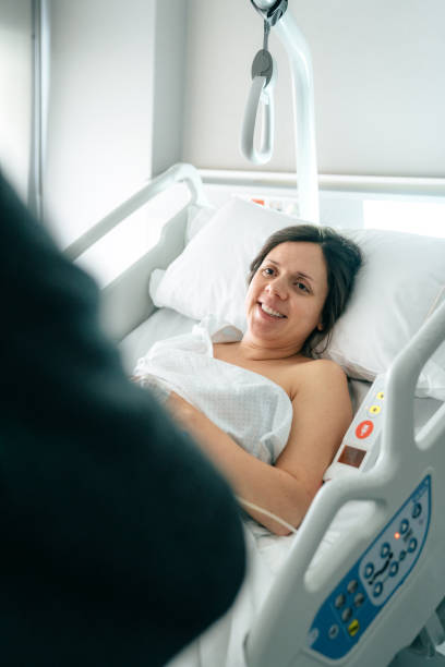 istock Woman lying on bed at hospital 1202709854