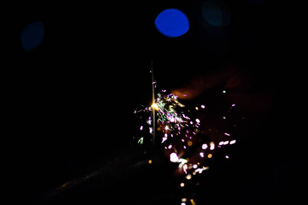 istock Sparks in the dark. Sparks. Christmas and New Year time. Magic light 1202709930