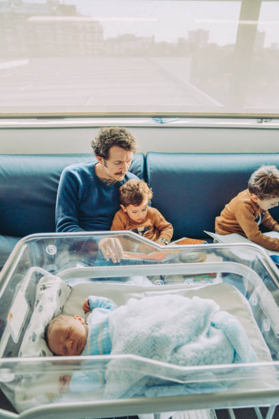 istock Father with his sons and a newborn 1202710150