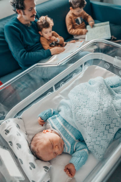 istock Father with his sons and a newborn 1202711087