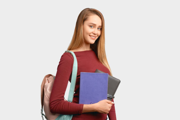 istock smiling girl holds leather notebooks in hand 1202713030