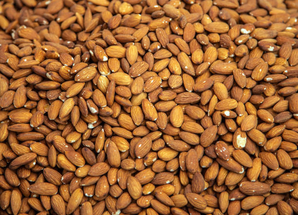 Natural background mix peeled Dry almond nut. Top view blur textures soft focus.