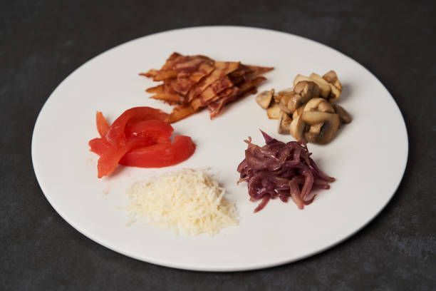 istock Traditional breakfast omelette with bacon, tomatoes, mushrooms, onion 1202713575