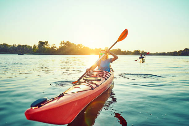 istock People kayak during sunset in the background. Have fun in your free time. 1202716632