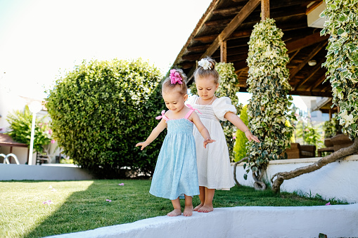 Two little girls having fun and running together