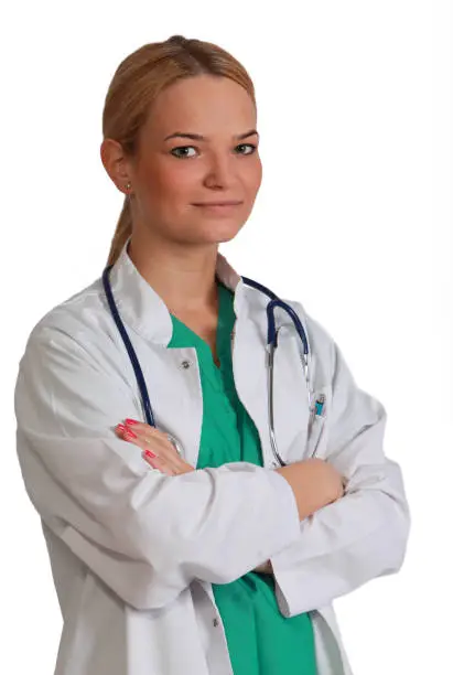 Portrait of a young female doctor isolated against a white background.