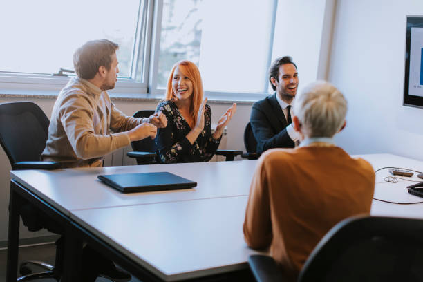 istock Young businessman presenting project strategy showing ideas on interactive whiteboard in office 1202718308