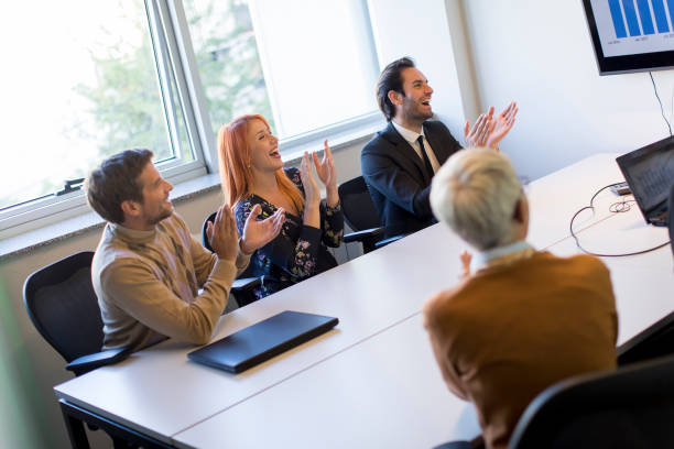 istock Young businessman presenting project strategy showing ideas on interactive whiteboard in office 1202718319