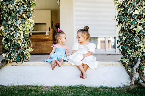 Two little girls having fun and running together