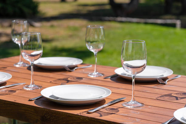 istock Served wooden table without a tablecloth. Cafe in the open air park 1202720670