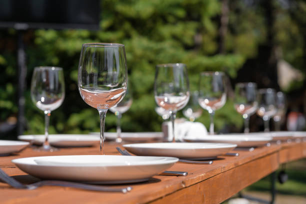 istock Served wooden table without a tablecloth. Cafe in the open air park 1202720800