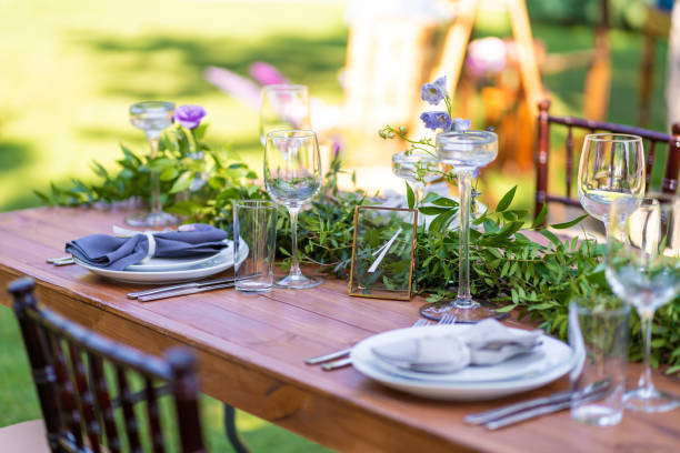 istock Preparing for an open-air party. Decorated with fresh flowers served tables. Table number. Decoration Details 1202720944