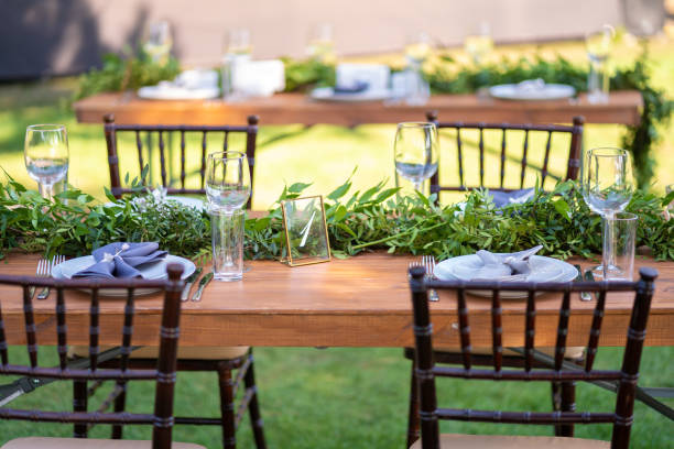 istock Preparing for an open-air party. Decorated with fresh flowers served tables. Table number. Decoration Details 1202720945