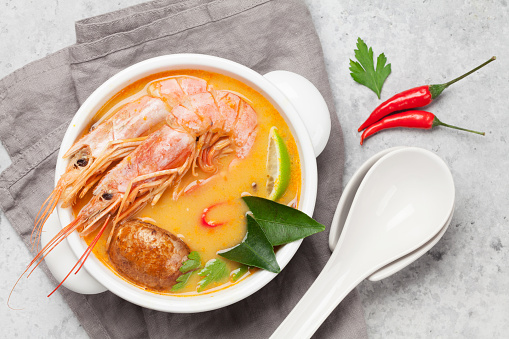 Tom Yum traditional Thai soup with seafood, mushrooms, coconut milk and hot spices. Top view