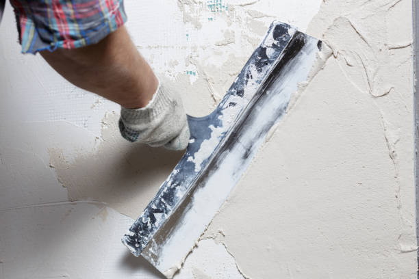 istock Hand of builder worker with a long spatula 1202722671
