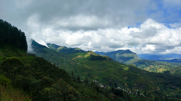 istock Beautiful landscape green mountain valley above which white clouds hang 1202728314