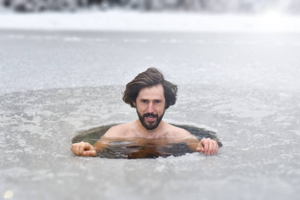 istock The young man have bath in cold water. Hardening. 1202728618