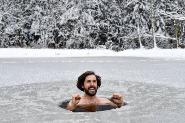 istock Young man have bath in cold water and does Wim hof method and gesturing 1202728635