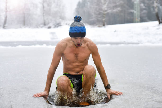 istock Young man have bath in cold water and Getting out from ice water 1202728650