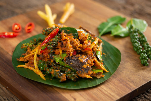 istock spicy stir Fried Smoke-grilled fish on chopping block. 1202728691