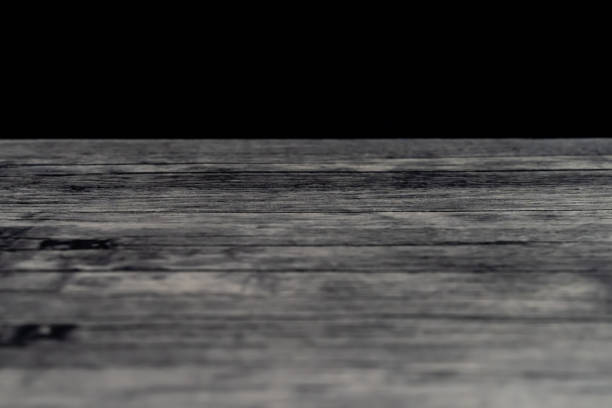 Wooden table top with defocus black wall background. Photo is taken with Sony A7III camera