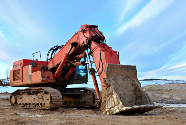 istock Excavator working in the mining quarry in winter time 1202730202