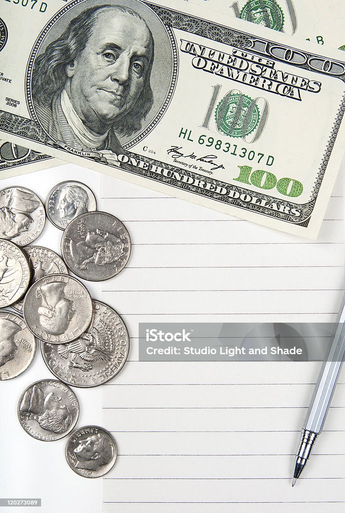Empty lined paper, money and pen Empty lined paper to white a shopping list, money and pen. American Culture Stock Photo