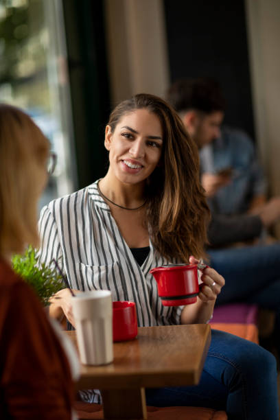 istock Female friends in a cafe having a talk 1202731096