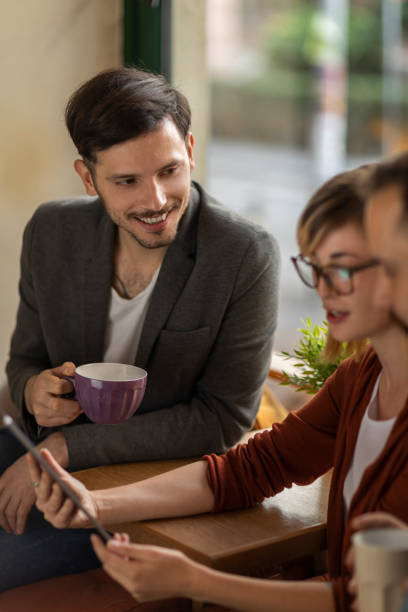 istock Group of young professionals in cafe having a break 1202731136