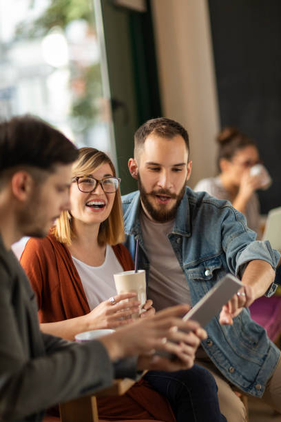 istock Group of young professionals in cafe having a break 1202731166