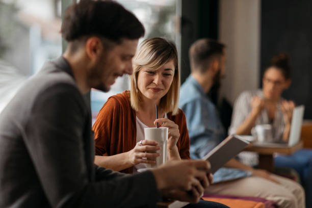 istock Young couple in cafe talking 1202731178