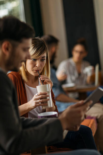 istock Young couple in cafe talking 1202731180