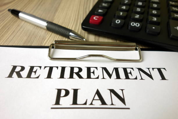 istock Text retirement plan on paper sheet with pen and calculator 1202731396