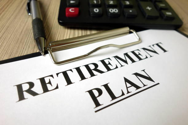 istock Text retirement plan on paper sheet with pen and calculator 1202731650