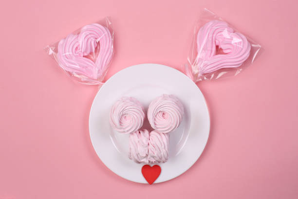 istock funny face is made by sweets on pink background 1202732698